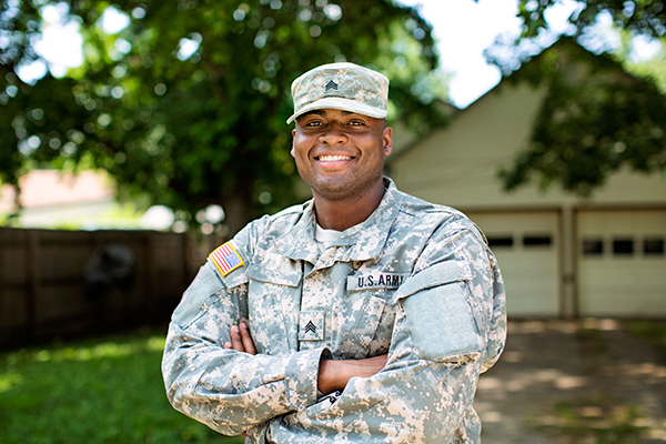 American soldier in front of his home